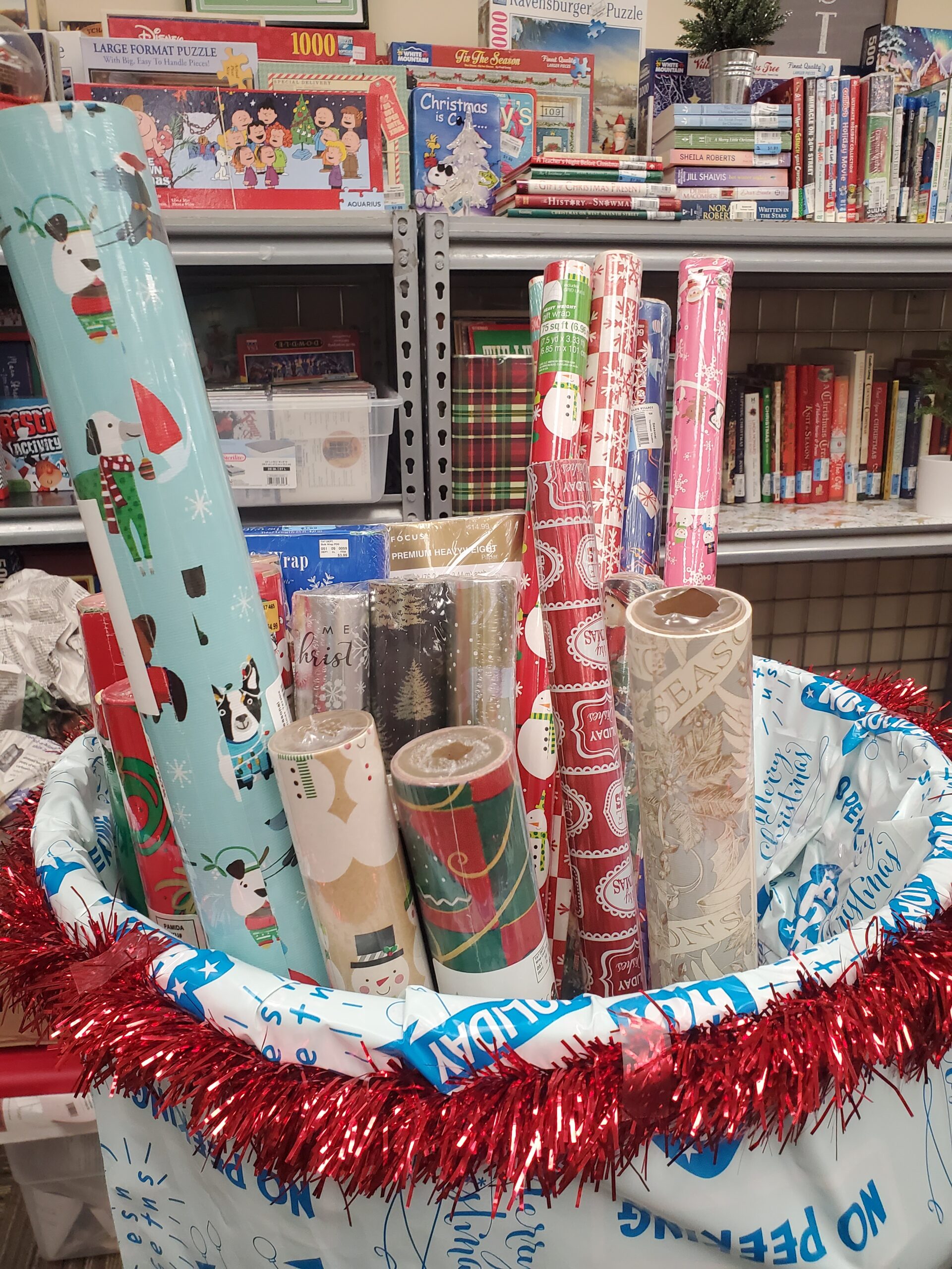 A variety of tubes of holiday wrapping paper for sale.